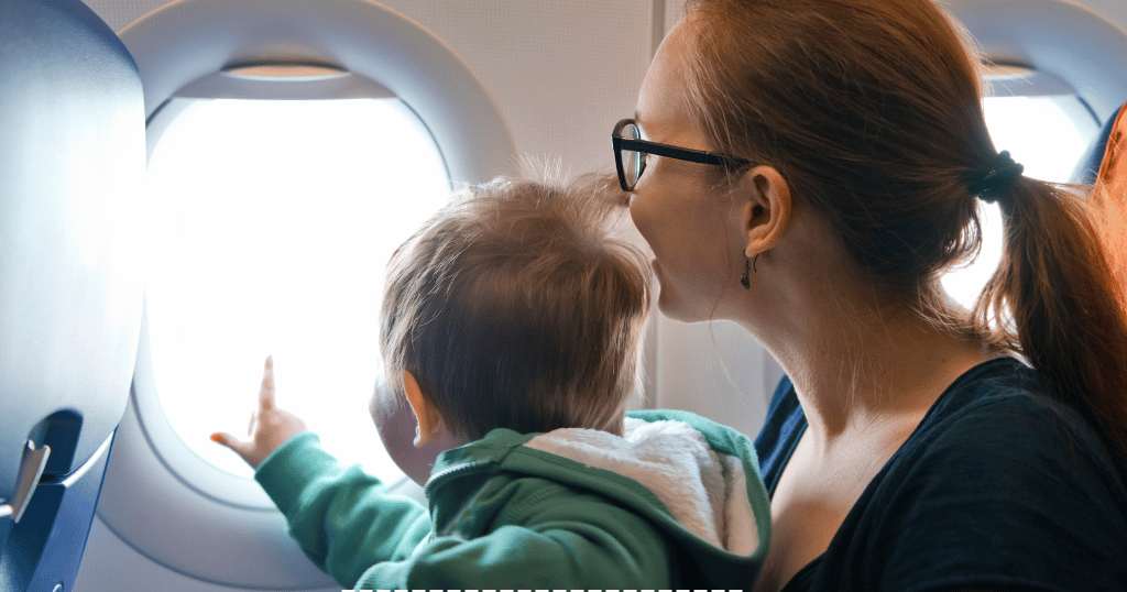 Bebe olhando viaje na jenela do aviao